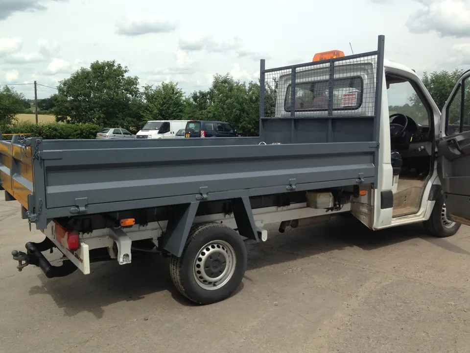 A tipper truck body blasted and repainted dark grey